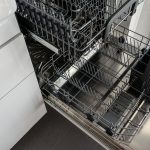 Lege roestvrijstalen vaatwasser open in een moderne keuken